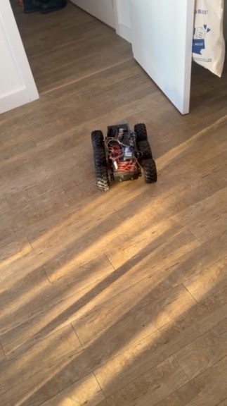 The six-wheeled robot driving across a wooden floor